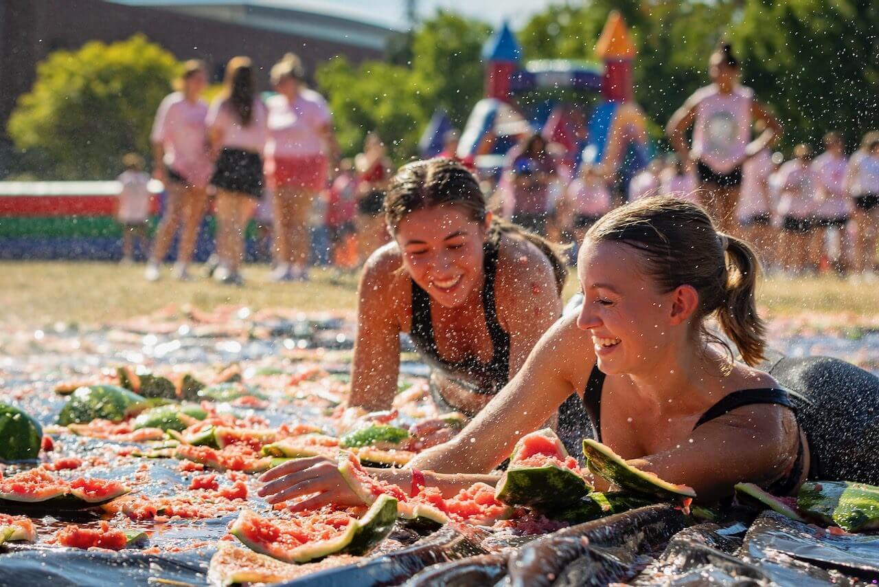 People enjoying watermelon-themed outdoor activity.
